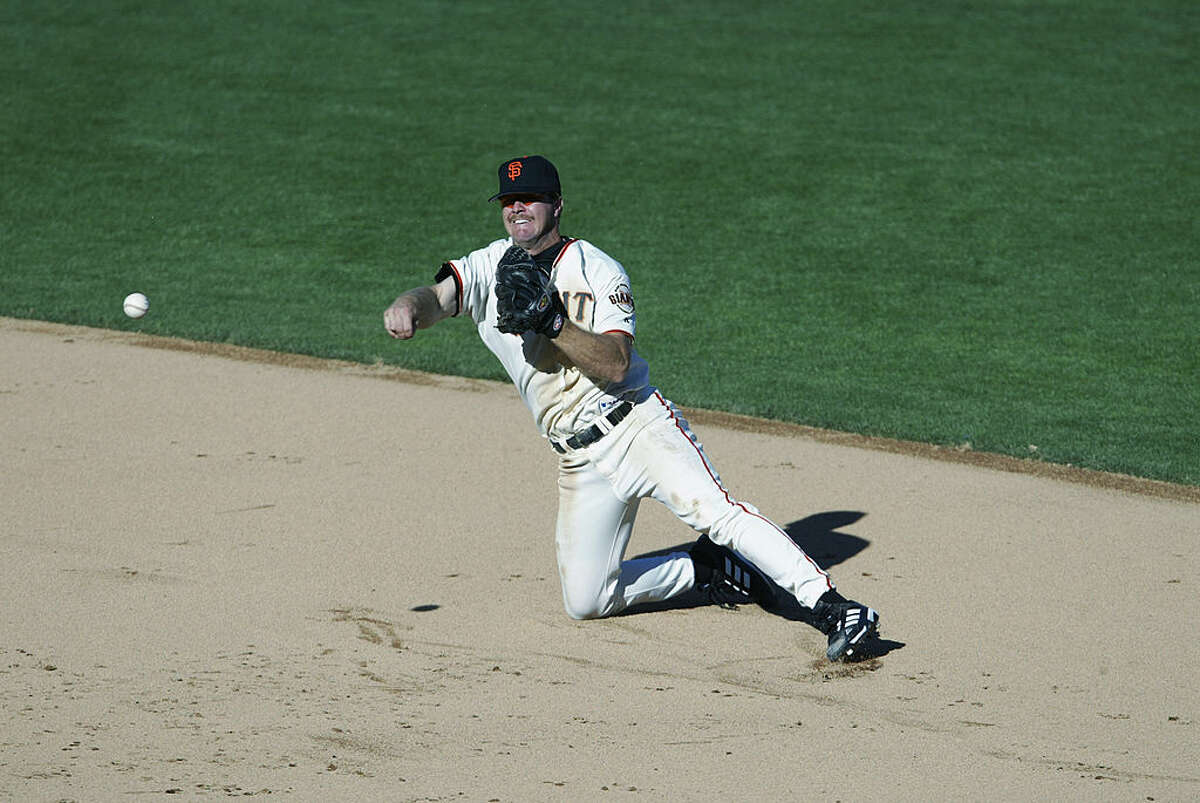 Second baseman Jeff Kent of the San Francisco Giants dives as he throws the ball during game three of the National League Division Series against the Atlanta Braves at Pac Bell Park in San Francisco, California on October 5, 2002.