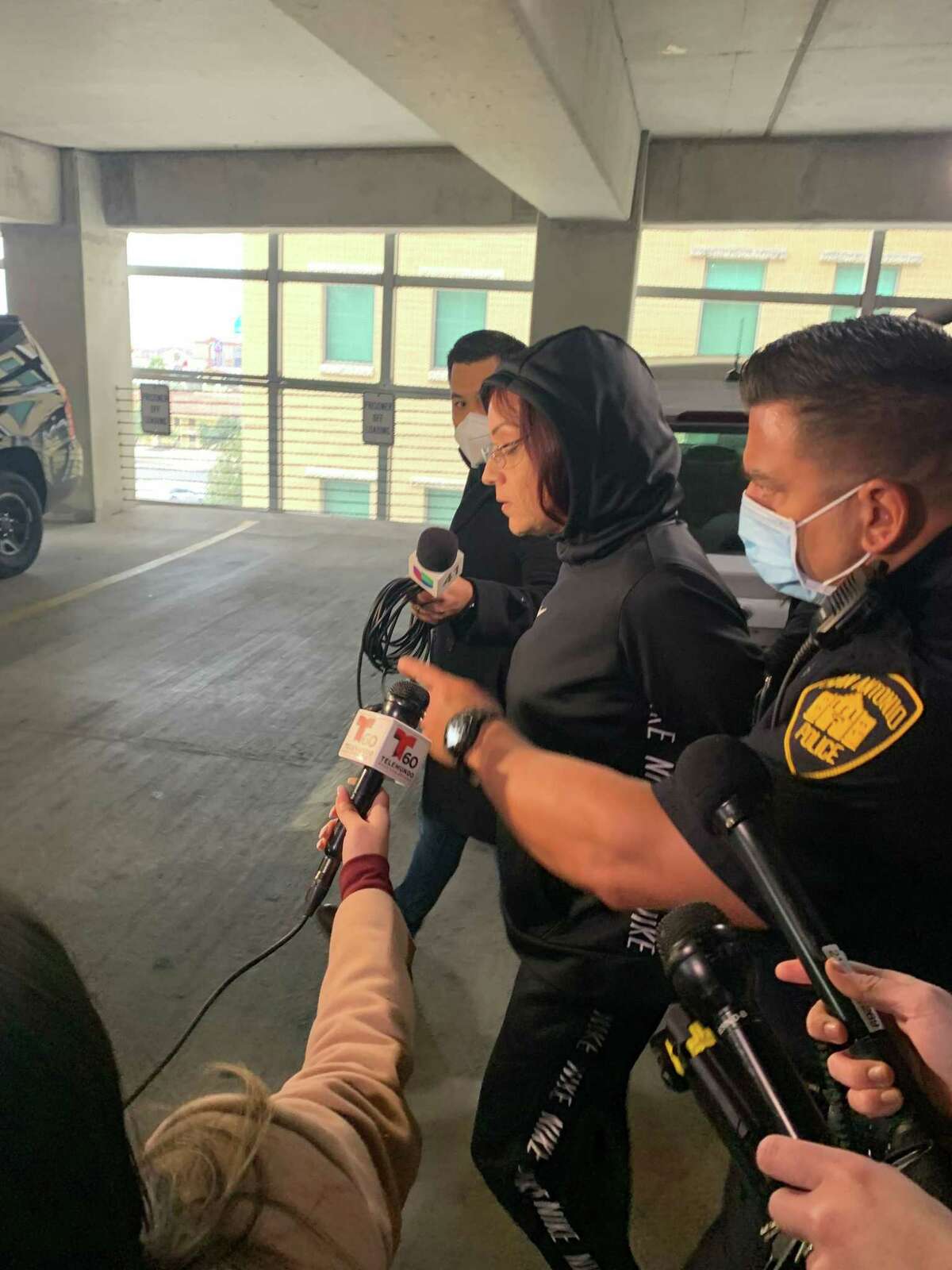 Priscilla Ann Salias, 37, is peppered with questions from reporters as San Antonio police lead her out. Salinas was arrested on two counts of child endangerment on Tuesday, Jan. 11, 2022. She is accused of leaving two toddlers alone and tied up in a Southeast Side home in San Antonio.