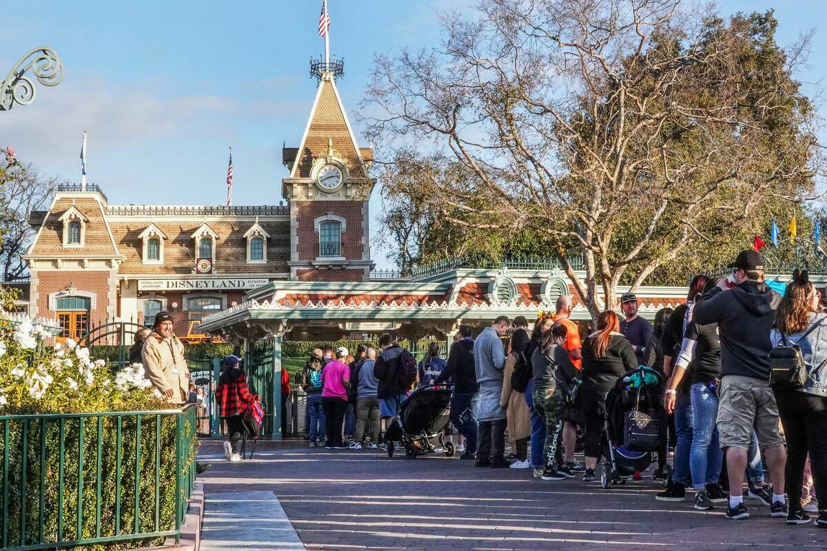 Guests wait to enter Disneyland Park on Jan. 13, 2020, in Anaheim, Calif.