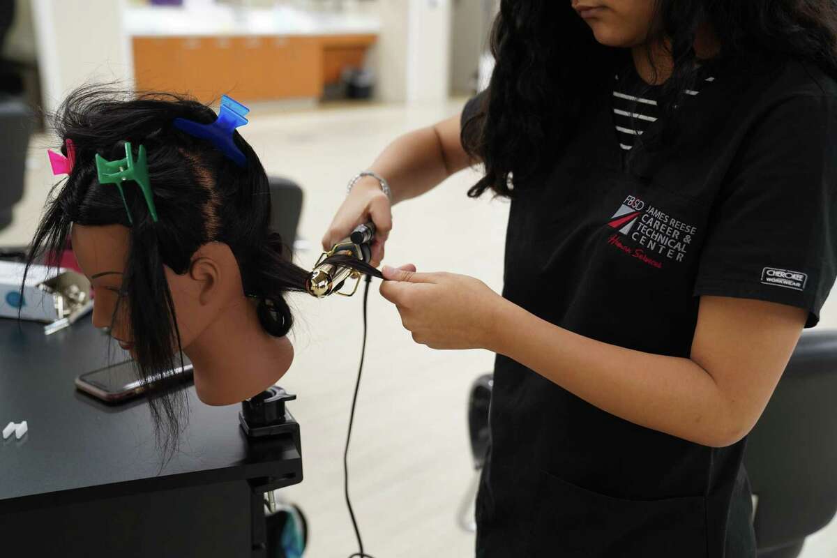 A Fort Bend ISD cosmetology student gains hands-on experience in the district’s CTE program.
