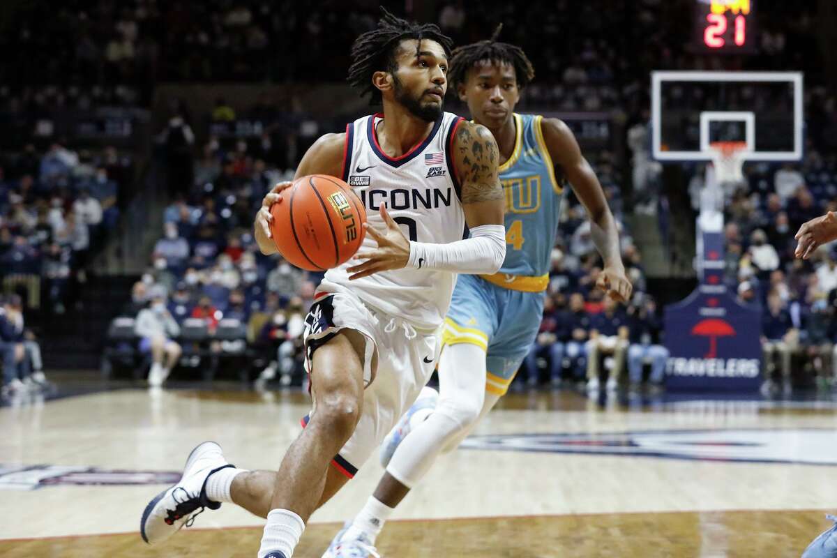 Connecticut's Jalen Gaffney, left, drives past LIU's Quion Burns, right, on his way to the basket during the first half of an NCAA college basketball game Wednesday Nov. 17, 2021, in Storrs, Conn. (AP Photo/Paul Connors)