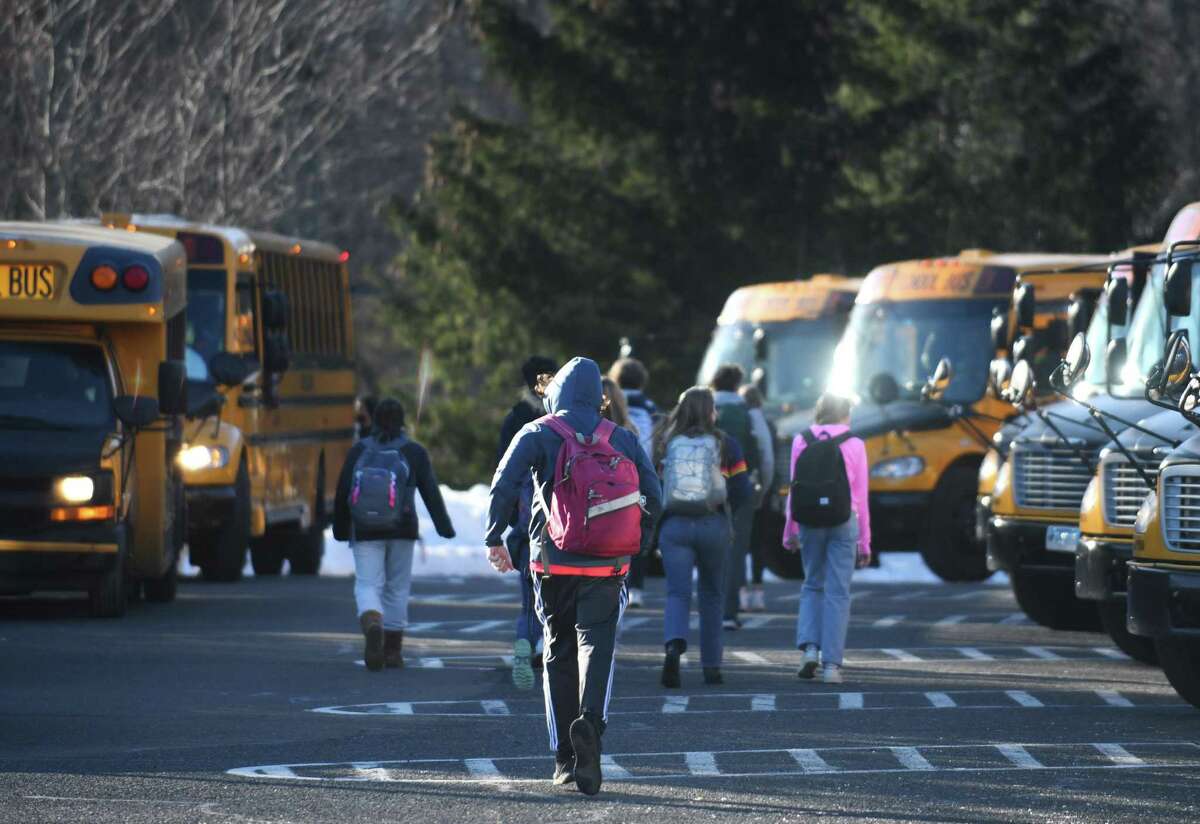 Students are dismissed at the end of the school day at Darien High School in Darien, Conn. Tuesday, Jan. 11, 2022.