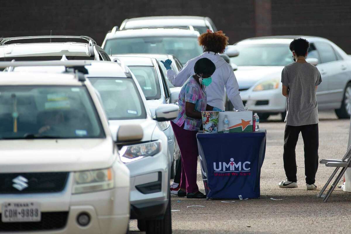 Staff prepares to administer Covid-19 tests to people lined up at the United Memorial Medical Center testing site at the PlazAmericas shopping mall parking lot last month. Federal officials said they terminated Medicare contracts at United Memorial Medical Center after the Houston hospital system failed yet another federal inspection.