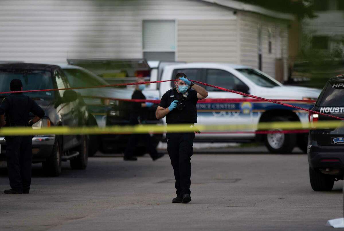 Houston Forensic Science Center Crime Scene Unit investigator collects evidences from a fatal shooting at 10800 block of Telephone Road Sunday, Oct. 3, 2021, at in Houston. One person deceased and three people injured at the mobile home park.