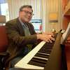 Frank Martignetti plays piano in his office on the West Campus of Sacred Heart University, in Fairfield, Conn. Jan. 11, 2022. Martignetti is director of SHU’s music education program.