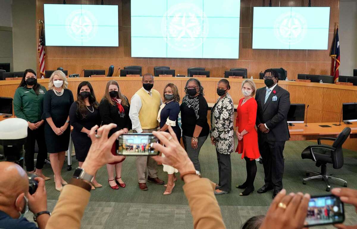 A group photo is taken of Millard House II, Houston ISD superintendent, center, with trustees and others after oath ceremony at Hattie Mae White Educational Support Center, 4400 W. 18th St., Tuesday, Jan. 11, 2022 in Houston.