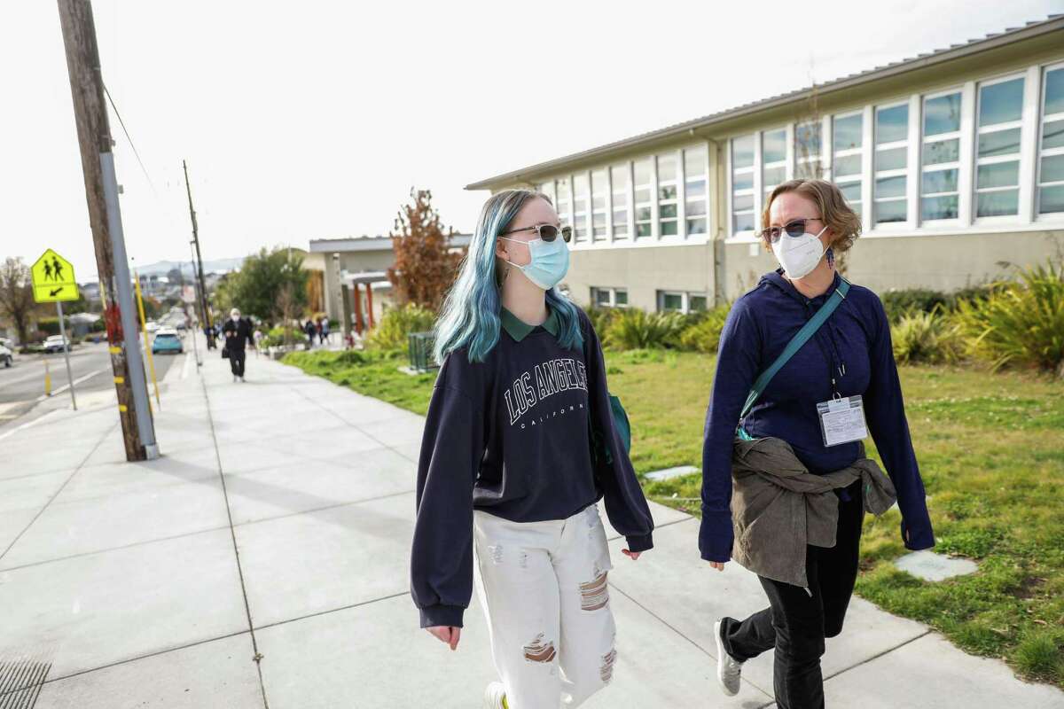 Mae Rabinovici (left) and mom Sharyl walk back to their car after Korematsu Middle School lets out for the day.