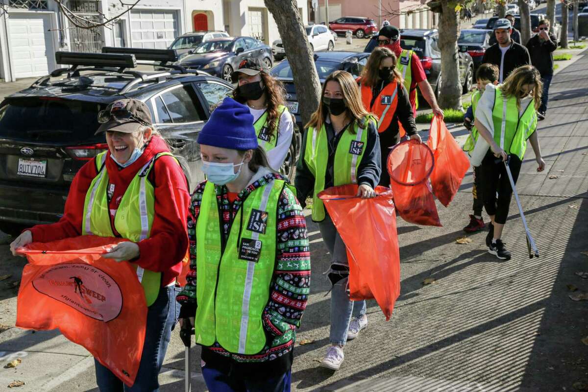 Volunteers clean up North Beach during a community effort organized by Refuse Refuse.