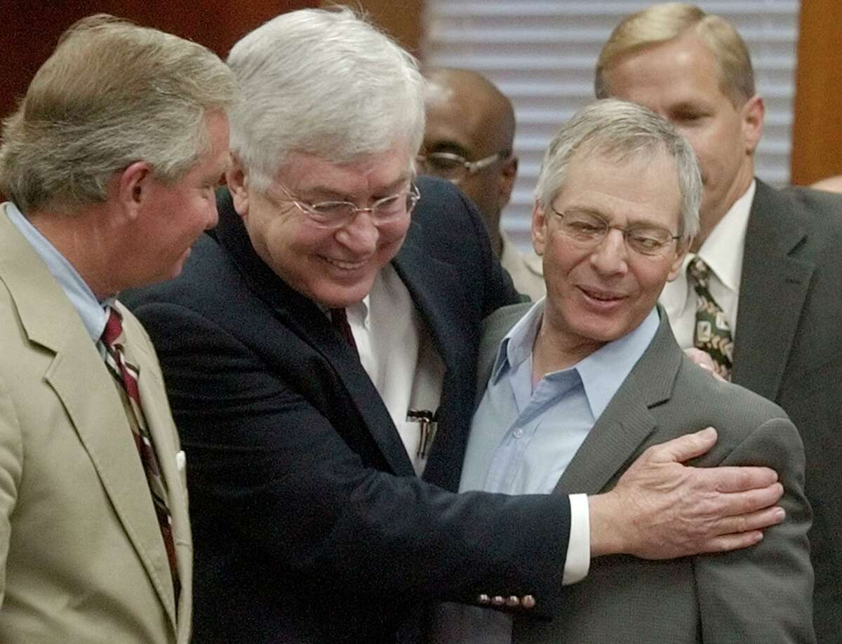 FILE - Multi-millionaire murder defendant Robert Durst, right, is congratulated by his attorneys Dick DeGuerin, left, and Mike Ramsey after receiving a verdict of not guilty Nov. 11, 2003, in Galveston, Texas. Durst, the wealthy New York real estate heir and failed fugitive who was dogged for decades with suspicion in the disappearance and deaths of those around him before he was convicted of killing his best friend and sentenced to life in prison, died on Monday, Jan. 10, 2022. He was 78.