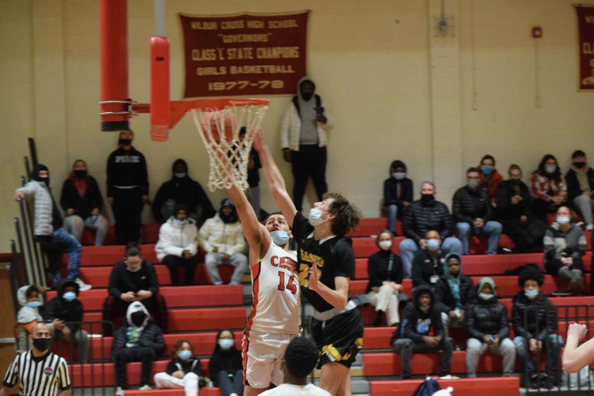Wilbur Cross' Fred Delgado goes up strong to the basket against Hand Tuesday in an SCC boys basketball game.
