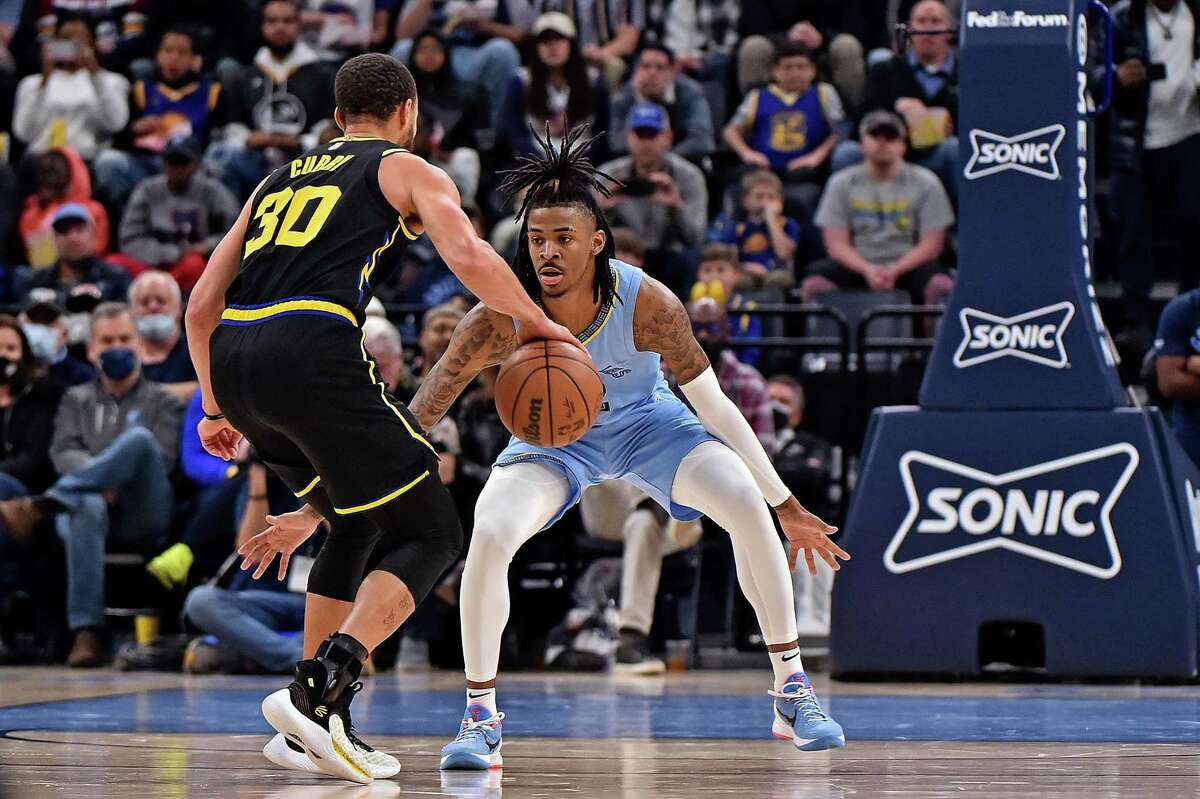 Ja Morant #12 of the Memphis Grizzlies guards Stephen Curry #30 of the Golden State Warriors during the second half at FedExForum on January 11, 2022 in Memphis, Tennessee.