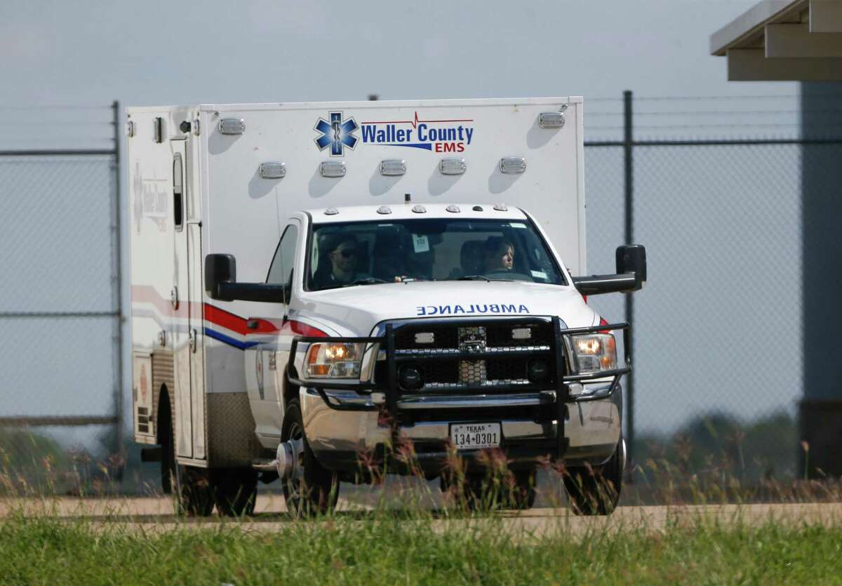 An ambulance exits Houston Executive Airport, from where an aircraft caught fire soon after a failed take-off attempt, on Tuesday, Oct. 19, 2021, in Brookshire.