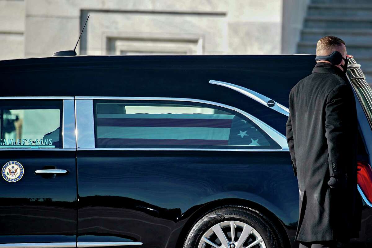 A hearse carrying the flag-draped casket of the late Sen. Harry Reid, D-Nev., arrives at the U.S. Capitol where he will lie in state, Wednesday, Jan. 12, 2022 in Washington.  Reid, who served five terms in the Senate, will be honored Wednesday in the Capitol Rotunda during a ceremony closed to the public under COVID-19 protocols. (Al Drago/Pool via AP)