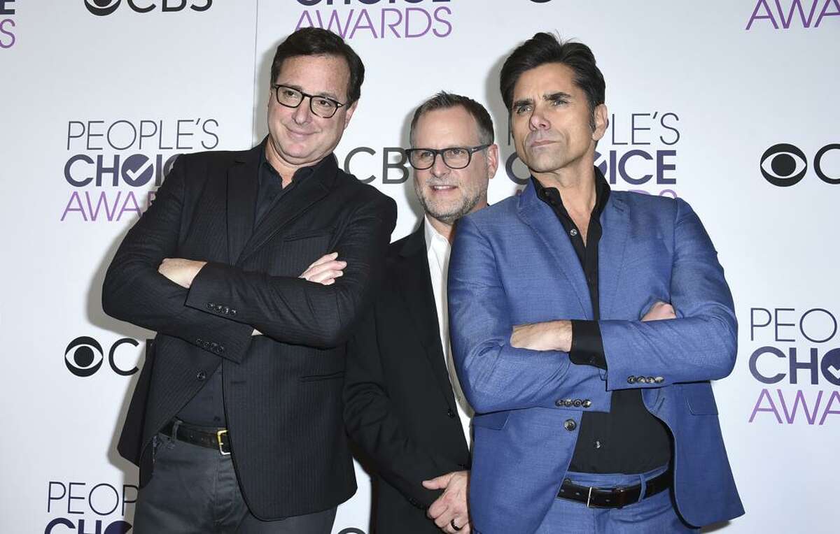 Bob Saget, from left, Dave Coulier and John Stamos, winners of the award for favorite premium comedy series for "Fuller House," pose in the press room at the People's Choice Awards at the Microsoft Theater in Los Angeles. (Pictured: Jan. 18, 2017.)
