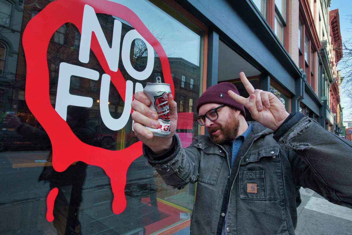 August Rosa, owner of No Fun, poses out in front of his business on Wednesday, Jan. 12, 2022, in Troy, N.Y.