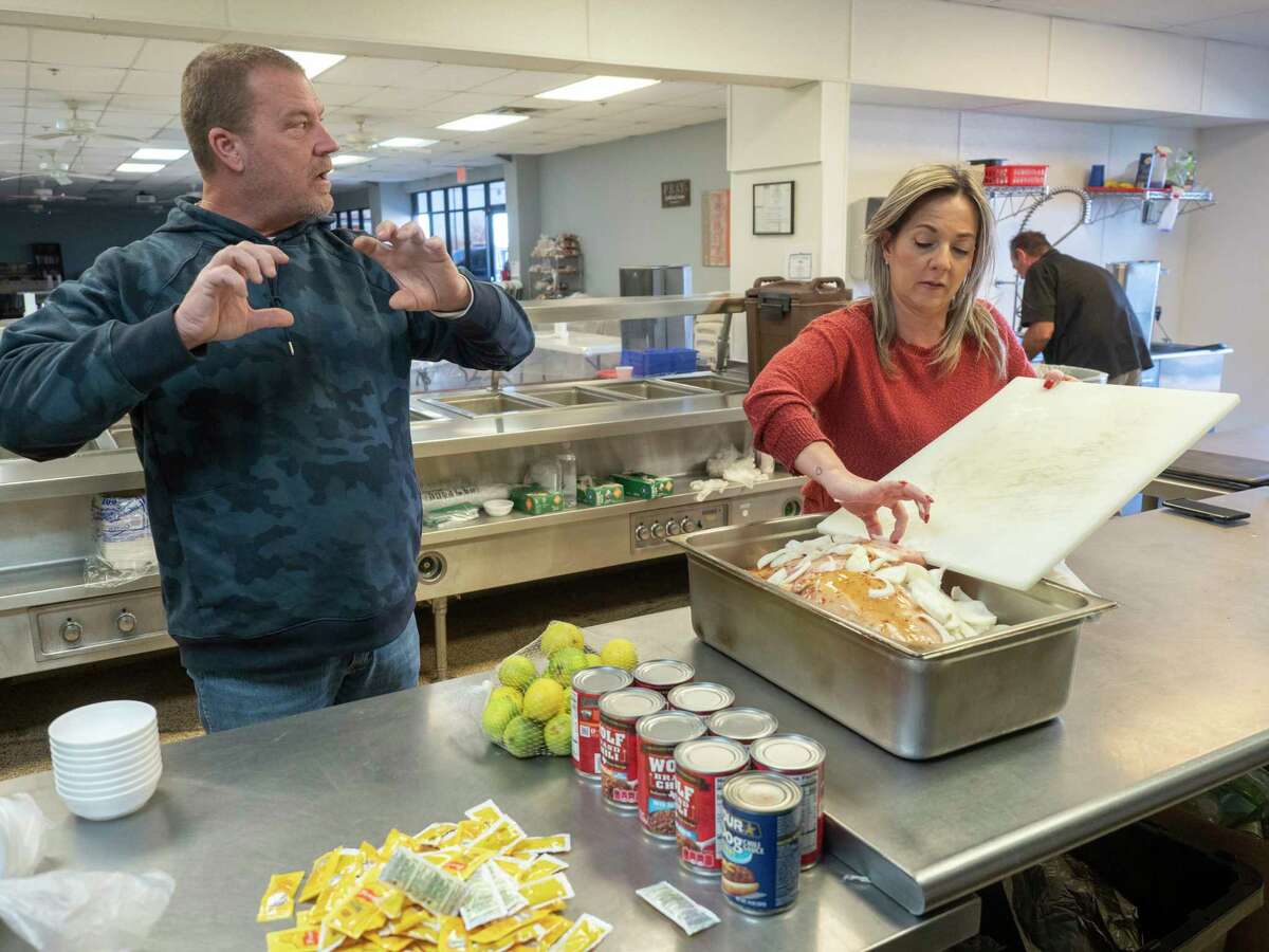 Tim Cline, kitchen director, talks as Maria Canevese, office assistant, helps prepare tomorrows dinner, roast pork 01/12/2022 at Breaking Bread Ministries. Dinner will continue to be served everyday as the construction of the new clinic will not effect the dinning area or kitchen. Tim Fischer/Reporter-Telegram