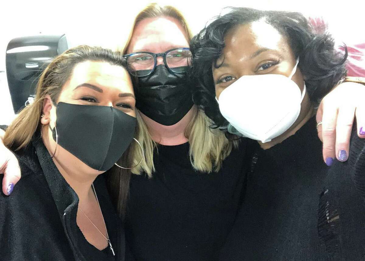 Middletown Public Schools staff took part in a statewide “blackout” event to highlight the need for increased school safety during the pandemic. From left, paraeducators Cindy Culp and Wendy Sheil are joined by secretary Kiarra Bennet.