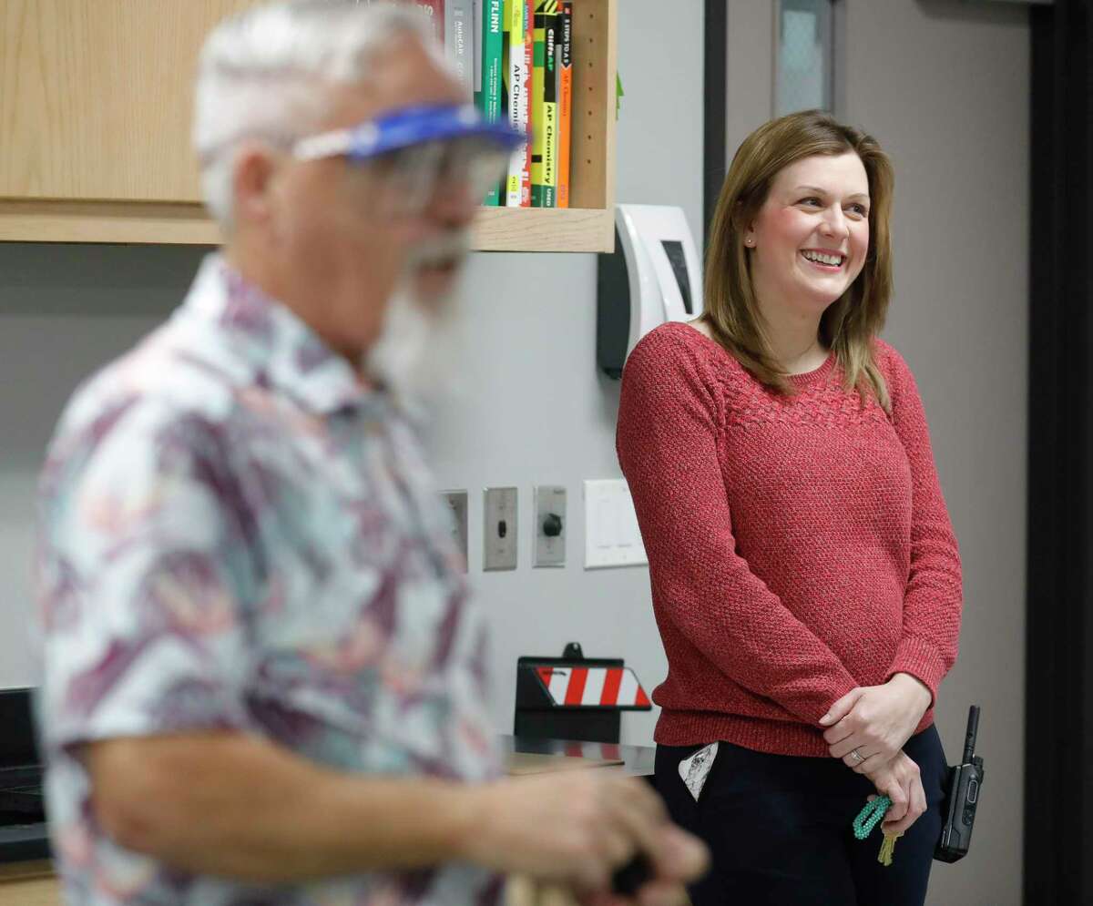 Willis High School Principal Stephanie Hodgins laughs as she hears students work through a chemistry experiment as teacher Gary Granger, left, looks on, Wednesday, Jan. 12, 2022, in Willis. Granger and other teachers raised $385 to help an elementary school teacher send her kids to daycare to allow her to continue teaching. Their act was part of Hodgins’ service day activity for the staff to help teach students the importance of socio-emotional learning, which has been affected during COVID-19 where students and teachers have not always been in the same classroom.