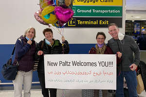 Members of the New Paltz for Refugees nonprofit, including co-chairs Beth Glace (second from right) and Robert Sabuda (far right), welcomed an Afghan family of seven in December.