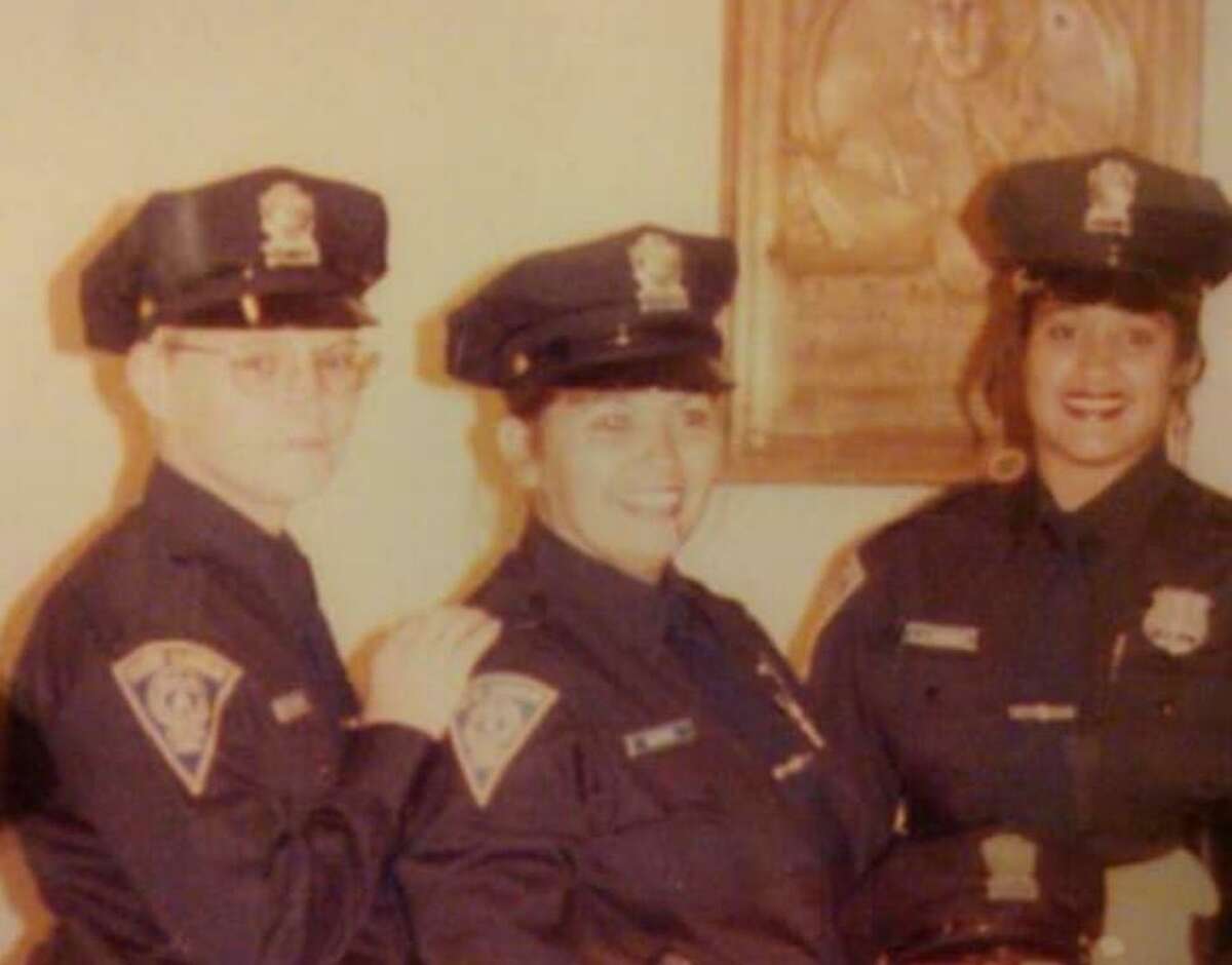 New Haven police Officer Diane Gonzalez, center, died Monday after slipping into a coma in 2008 after an on-duty crash.
