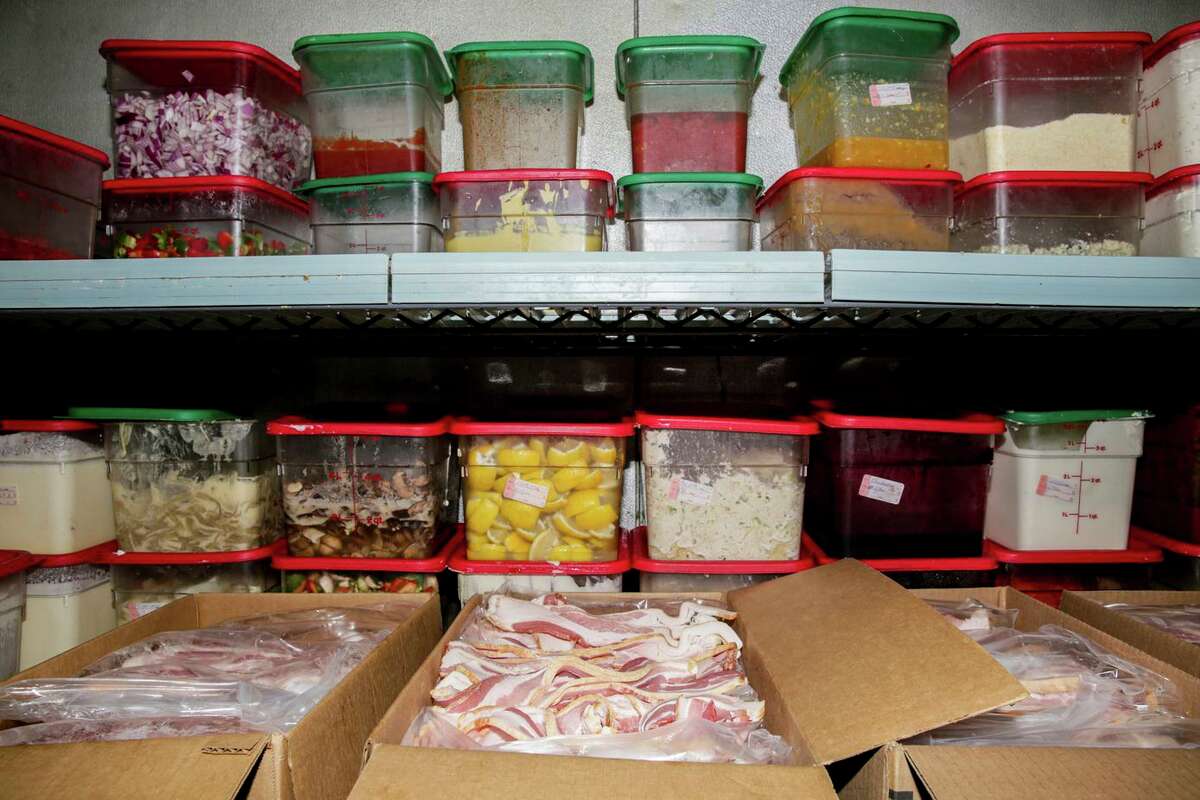 Boxed bacon can be seen in a walk-in cooler at Buttercup Diner in Concord. Diner owner Benjamin Shahvar says of Prop. 12: “This is going to be a major disruption to the industry.”
