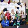 Nine Sacred Heart Greenwich students toss up their college caps to celebrate after a Commitment Night signing ceremony at the school in Greenwich on Wednesday. The school has 10 participants going to play a variety of college sports at D1 and D3 levels. Seated from left to right is Chelsea Hyland, Lauren Guiriceo, Caroline Nemec and Bella Adams. Standing from left to right is Kate Hong, Justine Hounsell, Annie O’Connor, Franny O’Brien and Libby Kaseta. Not present is Erin Griffin.
