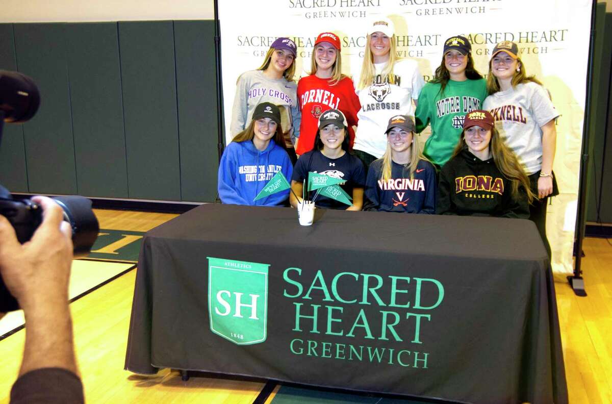 Nine Sacred Heart Greenwich students pose for photos after a Commitment Night signing ceremony at the school in Greenwich on Wednesday. The school has 10 participants going to play a variety of college sports at D1 and D3 levels. Seated from left to right is Chelsea Hyland, Lauren Guiriceo, Caroline Nemec and Bella Adams. Standing from left to right is Kate Hong, Justine Hounsell, Annie O’Connor, Franny O’Brien and Libby Kaseta. Not present is Erin Griffin.