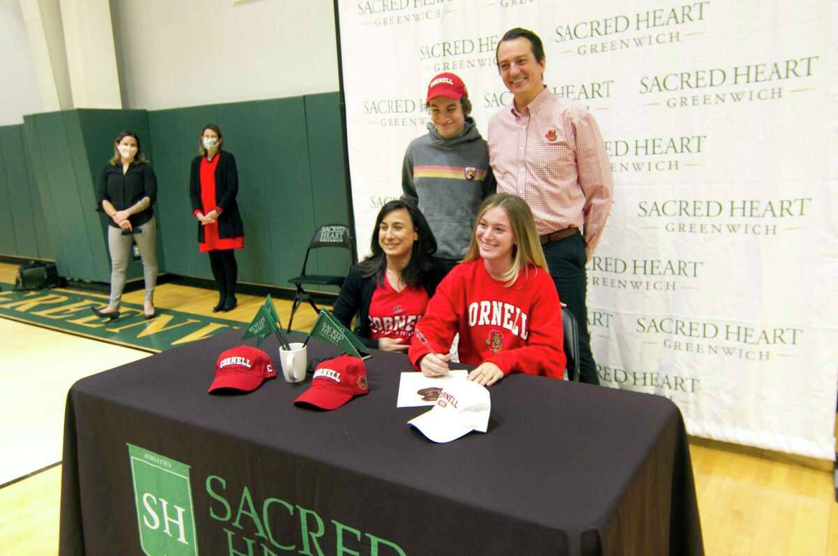 Sacred Heart Greenwich student Justine Hounsell poses with her family during a Commitment Night signing ceremony at the school in Greenwich, Conn., on Wednesday Jan. 12, 2021. The school has 10 participants going to play a variety of college sports at D1 and D3 levels.