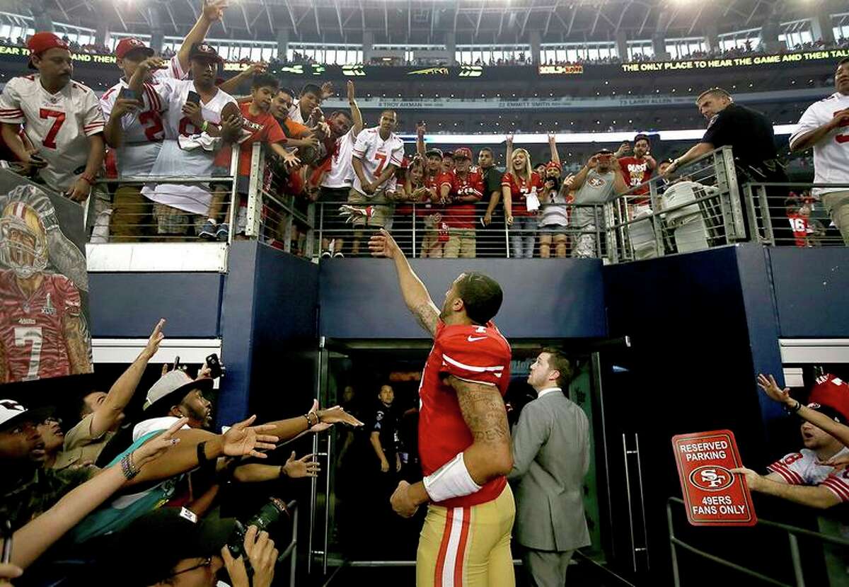 Then-49ers quarterback Colin Kaepernick found friendly faces in the stands after San Francisco defeated the Dallas Cowboys in a 2014 game in Arlington, Texas.