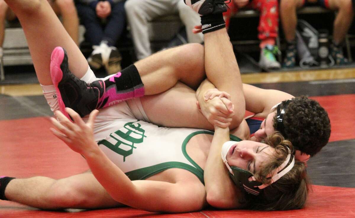 Big Rapids' Connor Randle (back) works at pinning his Central Montcalm opponent in CSAA wrestling action on Wednesday.