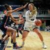 Butler forward Sydney Jaynes (32) loos to pass around Connecticut forward Olivia Nelson-Ododa (20) in the second half of an NCAA college basketball game in Indianapolis, Wednesday, Jan. 12, 2022. UConn won 92-47. (AP Photo/AJ Mast)