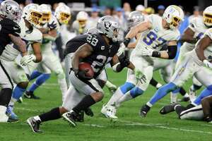 Running back Josh Jacobs, No. 28, of the Las Vegas Raiders runs against the Los Angeles Chargers in overtime of their game at Allegiant Stadium on Jan. 9, 2022 in Las Vegas, Nevada. The Raiders defeated the Chargers 35-32, the latest game shown on NBC Sports’ Sunday Night Football.