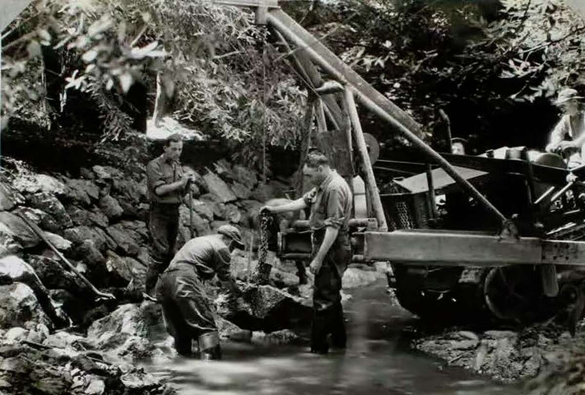 California Conservation Corps workers place rocks in Redwood Creek at Muir Woods in the 1930s.