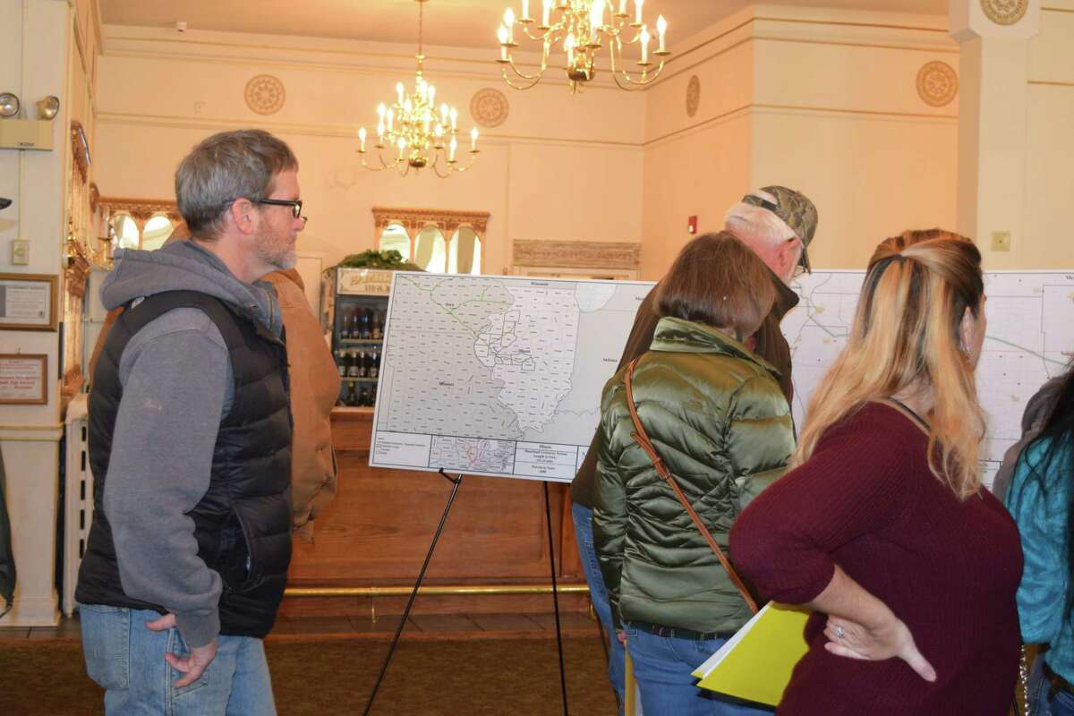 Those attending an informational meeting about the Heartland Greenway system for a proposed carbon-capture pipeline look at maps of the proposed pipeline.