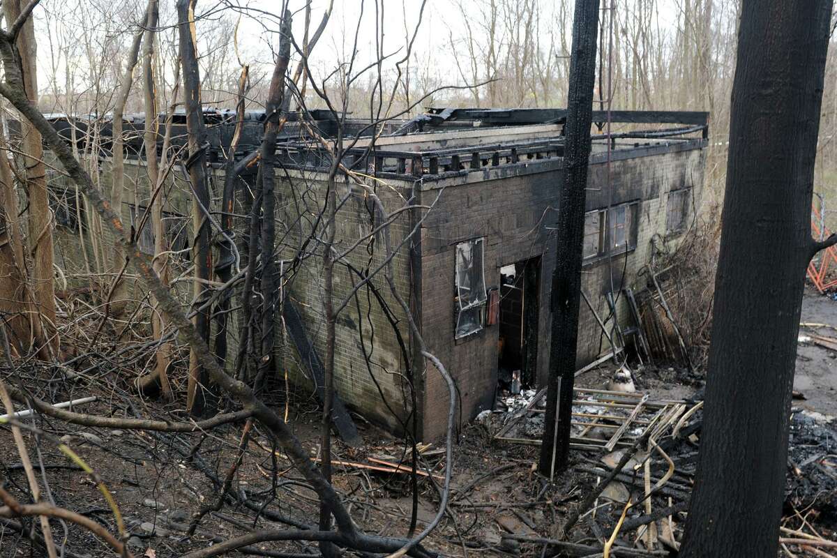 The remains of an abandoned building that was part of a fire that broke out Sunday on the grounds of the former Raymark ball field on Frog Pond Rd., in Stratford, Conn. April 11, 2016.