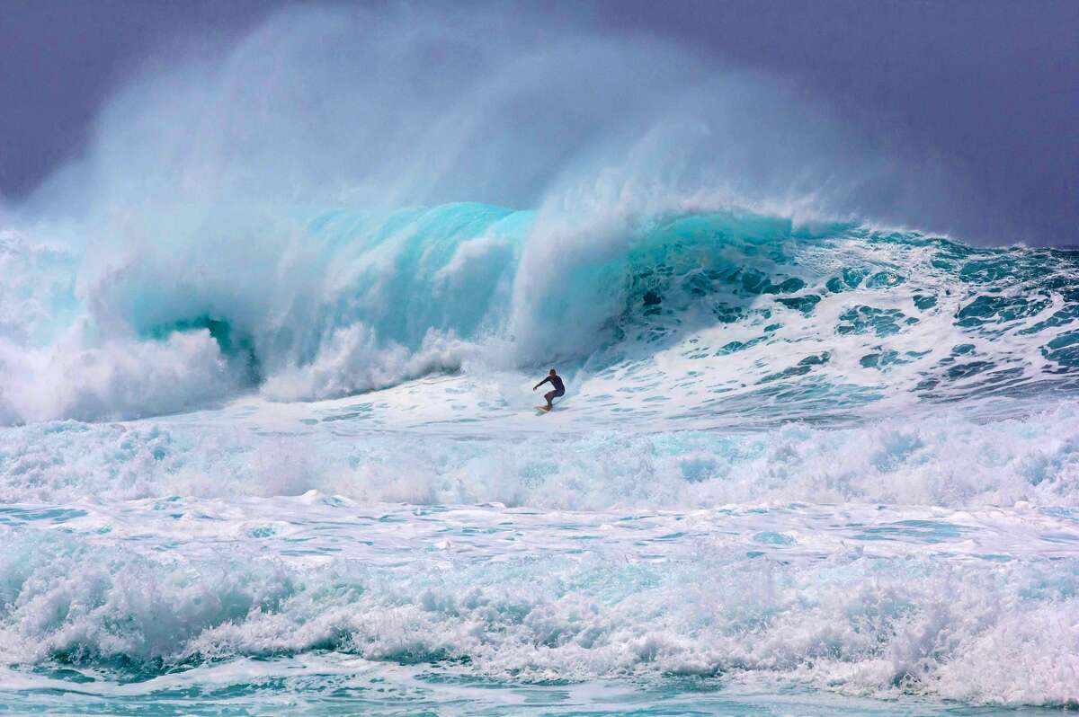 A surfer rides the waves at the Banzai Pipeline in Pupukea on Oahu's north shore.