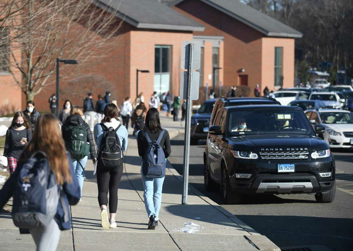 Students are dismissed at the end of the school day at Darien High School in Darien, Conn. Tuesday, Jan. 11, 2022.