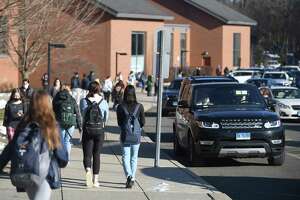 Students are dismissed at the end of the school day at Darien High School in Darien, Conn. Tuesday, Jan. 11, 2022.