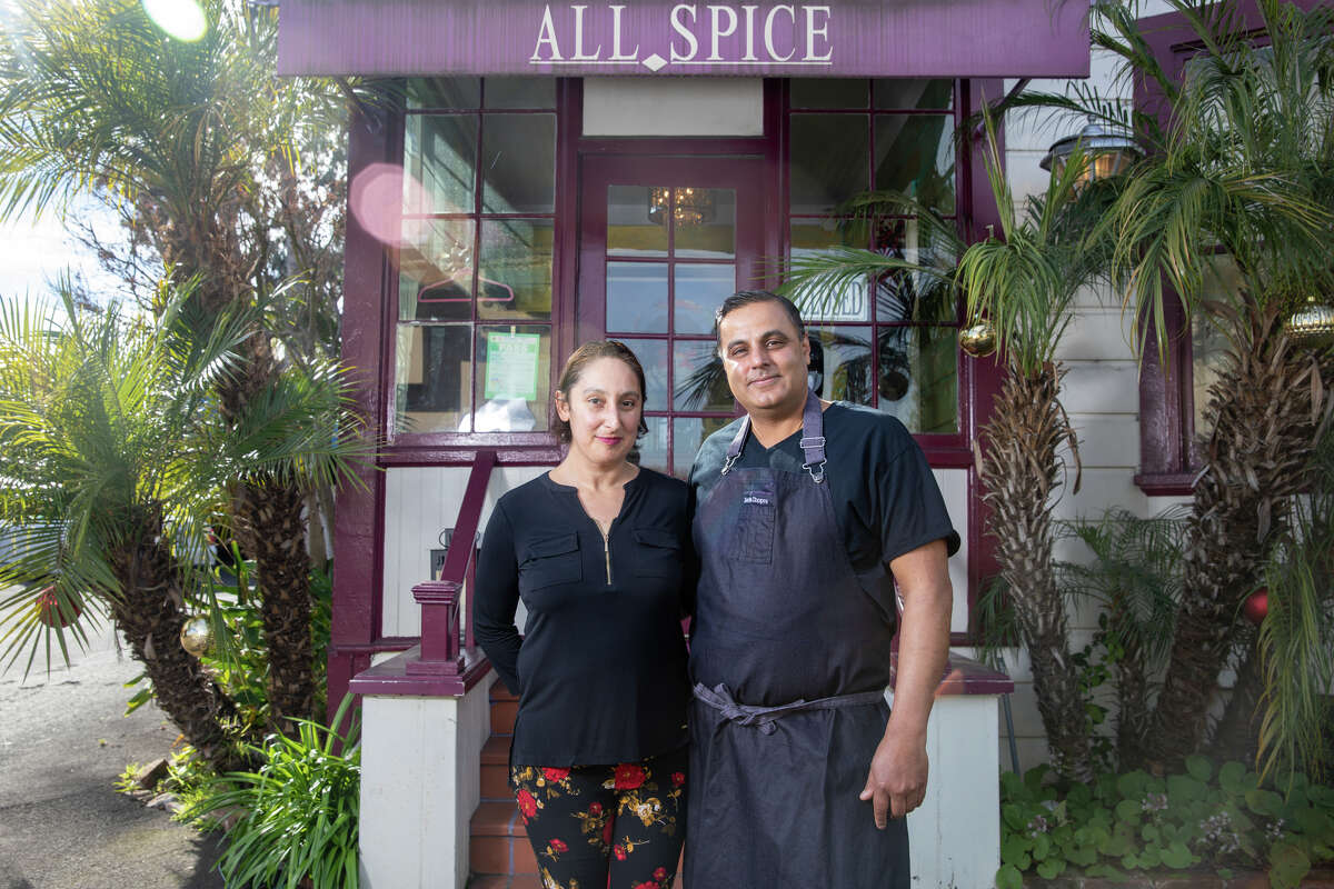 Left to right, owners Shoshana Wolff and Sachin Chopra stand outside All Spice restaurant in San Mateo, Calif., on Jan. 11, 2022. The restaurant is in a historic 1906 Victorian home.