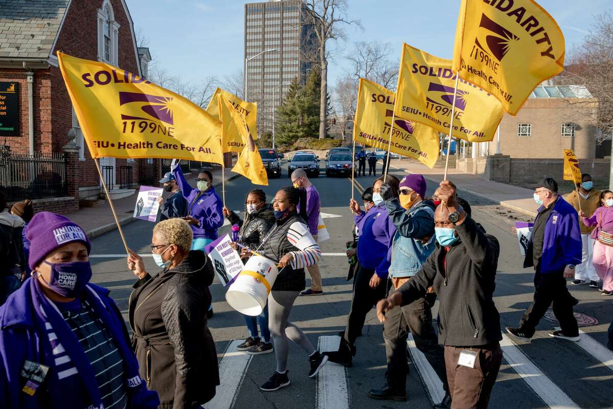 Long-term care workers block the intersection at the Department of Social Services in March 2021 to draw attention to the treatment of caregivers. Protestors asked for better wages and benefits, including affordable health insurance and retirement options and paid time off.
