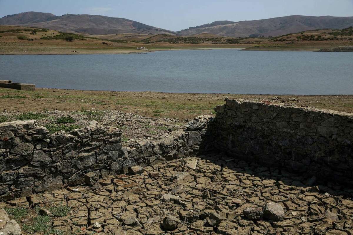 Low water levels at Nicasio Reservoir amid drought conditions reveal stone building foundations in the Nicasio Valley region in Marin County in July.
