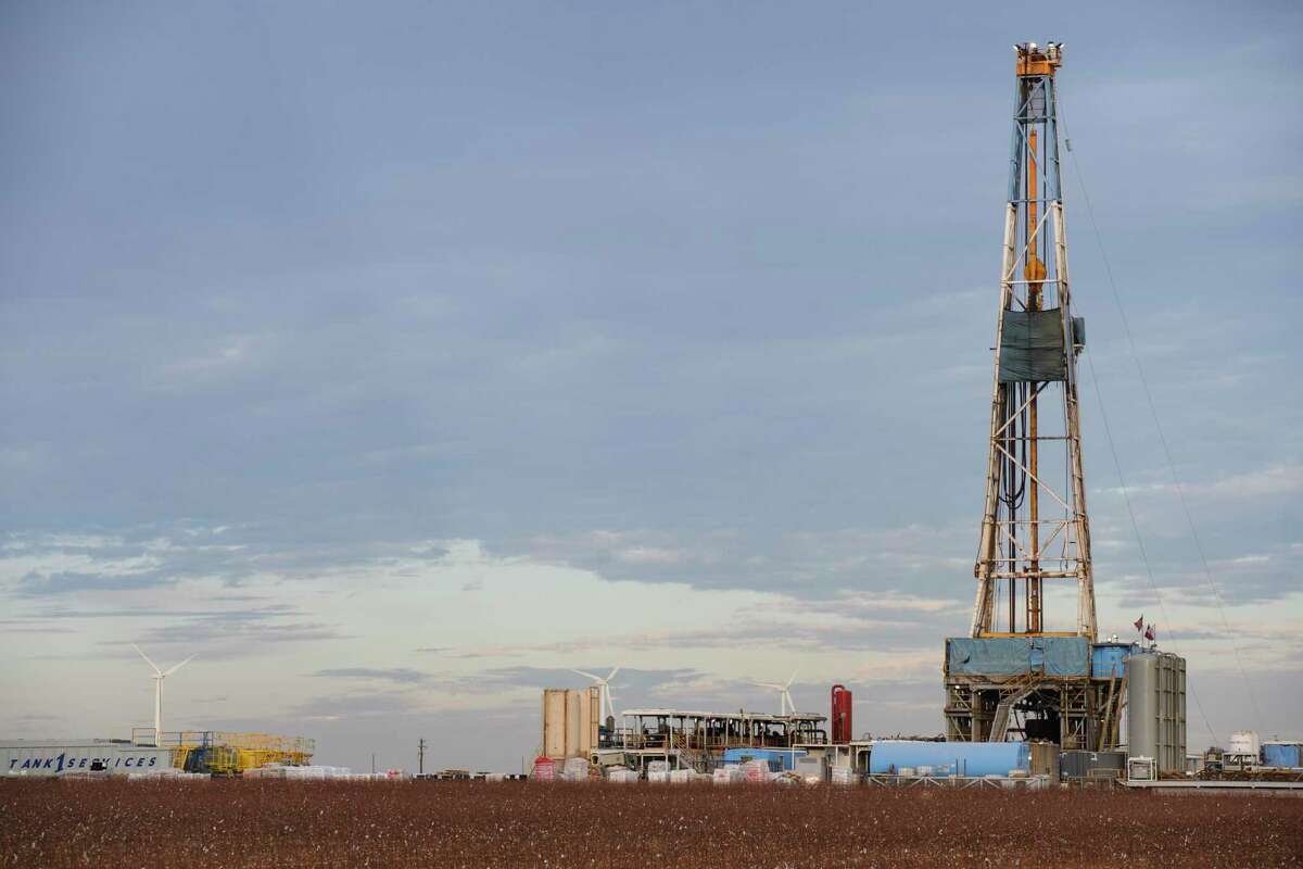Latshaw drilling rig #19 operates near a wind farm in Stanton, Texas, on Monday, Dec. 27, 2021. According to the United States Geological Survey, at approximately 7:55 p.m. on Monday, the Texas Seismological Network detected a 4.5 magnitude earthquake 11 miles north of Stanton. (Eli Hartman/Odessa American via AP)