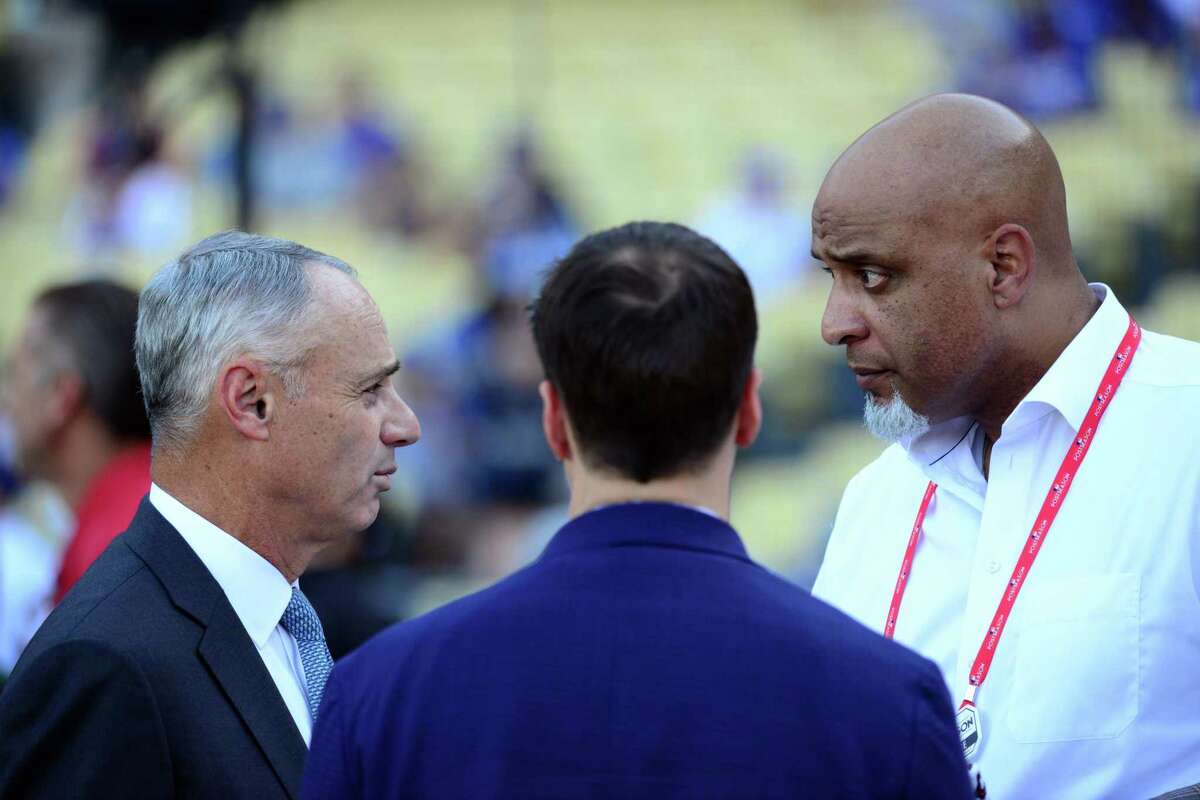 LOS ANGELES, CA - OCTOBER 25: Major League Baseball Commissioner Robert D. Manfred Jr. talks with Executive Director of the Major League Baseball Players Association Tony Clark during batting practice prior to Game 2 of the 2017 World Series between the Houston Astros and the Los Angeles Dodgers at Dodger Stadium on Wednesday, October 25, 2017 in Los Angeles, California. (Photo by LG Patterson/MLB via Getty Images)