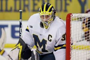 FILE - Michigan's Strauss Mann plays during an NCAA hockey game on Wednesday Dec. 8, 2020, in Ann Arbor, Mich. Former Michigan goaltender Strauss Mann, who is now playing in the Swedish Hockey League, is expected to be the U.S. starter for the 2022 Winter Olympics. The United States and other countries needed to pull from the college ranks and European leagues after the NHL decided not to send players to Beijing. (AP Photo/Al Goldis, File)