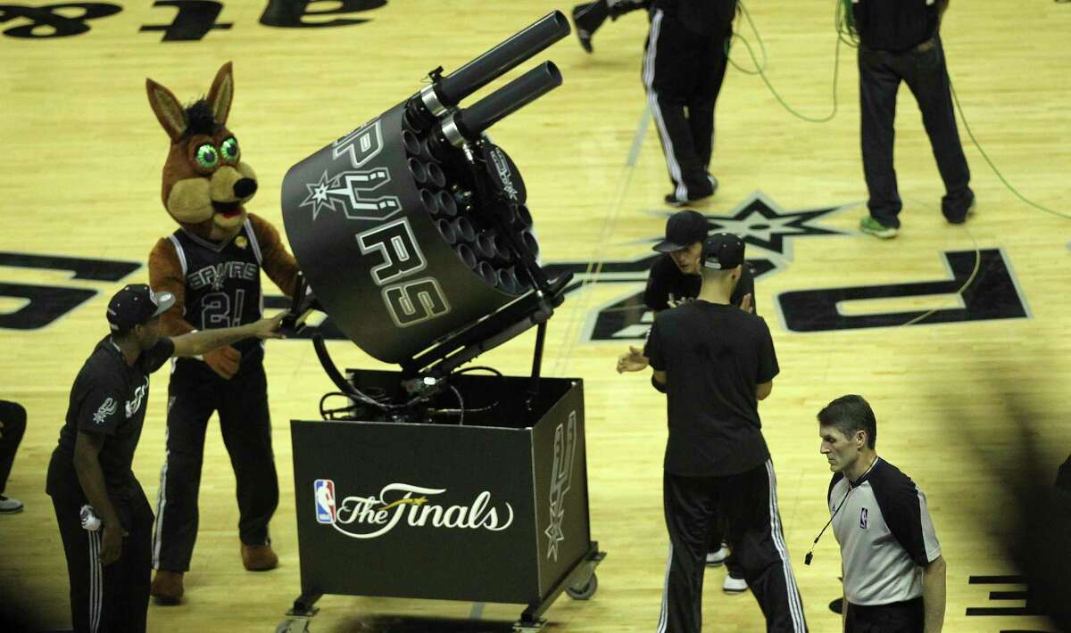 The SpursCoyote gets ready to shoot the Gatlin T-shirt gun during game one of the NBA Finals against the Miami Heat in 2014. Former Spurs Coyote Tim Derk, pictured at his home in San Antonio, was instrumental in the development of the T-shirt cannon, the propulsive device that is now ubiquitous at most sporting events.