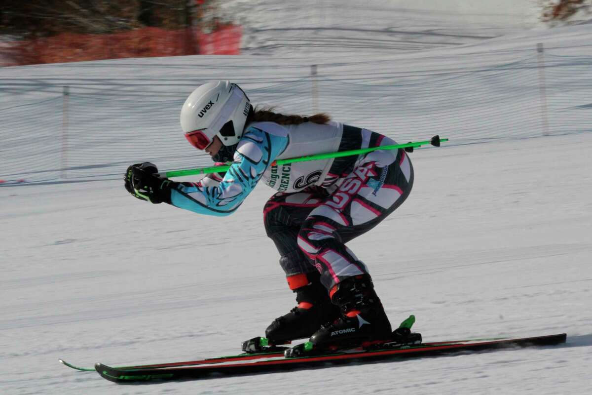 In this file photo, Michayla Bell speeds to the finish in the giant slalom last season. Bell placed first in both the slalom and giant slalom during Onekama's season opener at Crystal Mountain on Wednesday.