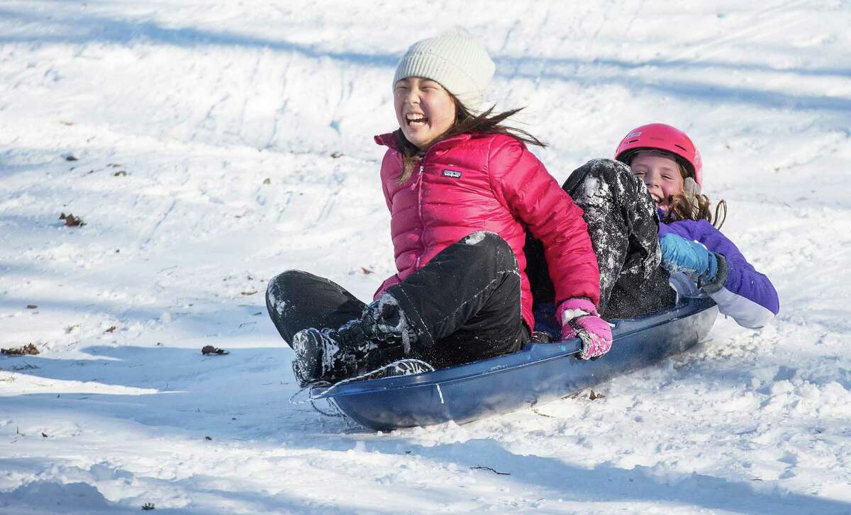 Katherine Shim and Mackenzie Dobson, both 10, of Wilton, sled at the G & B Cultural Center in Wilton. Saturday, Jan. 8, 2022.
