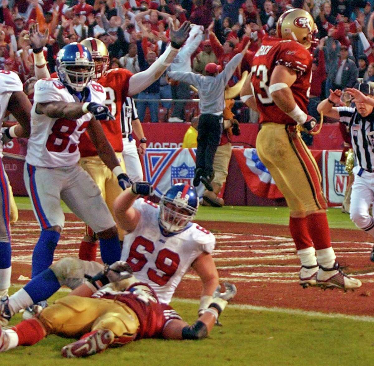 The Giants lobby for a pass-interference penalty — not given — after an incomplete pass to offensive lineman Rich Seubert (69) at the end of a wild-card playoff game in 2003.