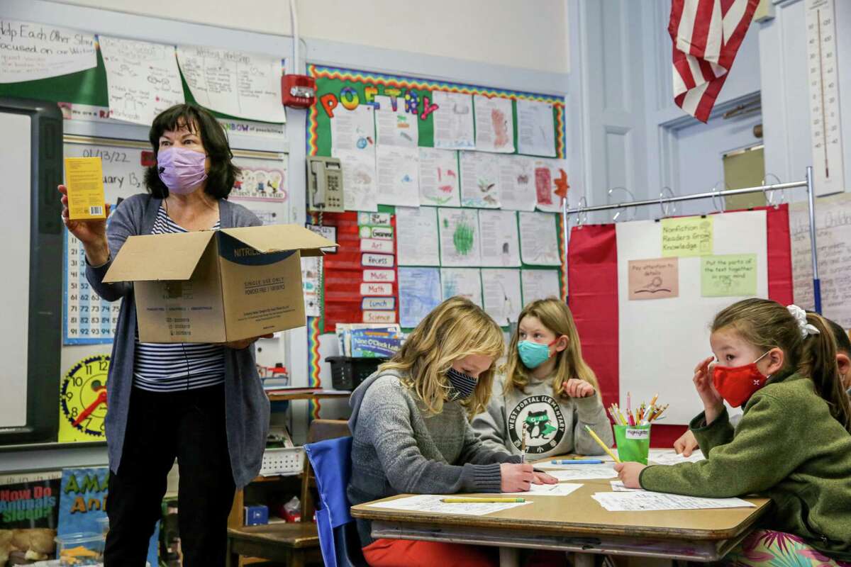 Second-grade teacher Mary Peralta speaks to her students about at-home COVID-19 testing kits at West Portal Elementary School in San Francisco.