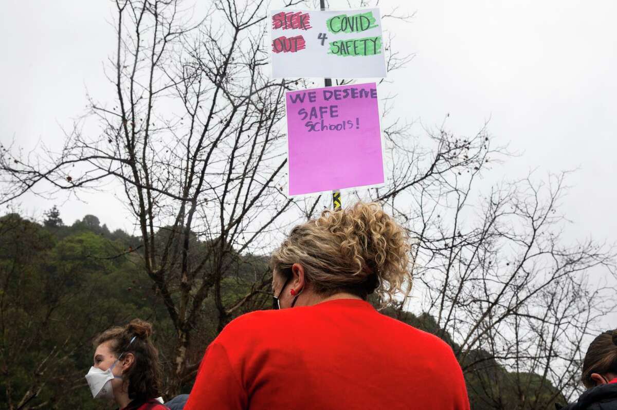 Oakland teachers gather at Leona Canyon Trail to decorate their cars before participating in a car caravan protest in Oakland on Jan. 7. Teachers called a second sickout on Thursday as the Omicron variant surges.